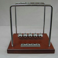 Newton's Cradle with Brown Wood Base and Silver Plate